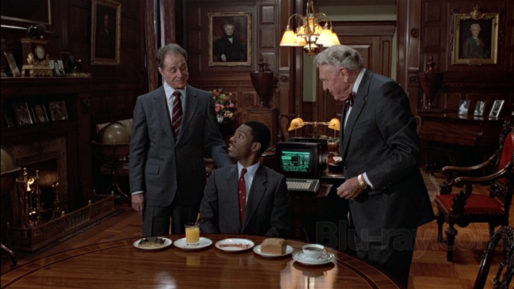 Randolph and Mortimer Duke with Billy Ray Valentine in the mahogany-paneled office, a scene from Trading Places